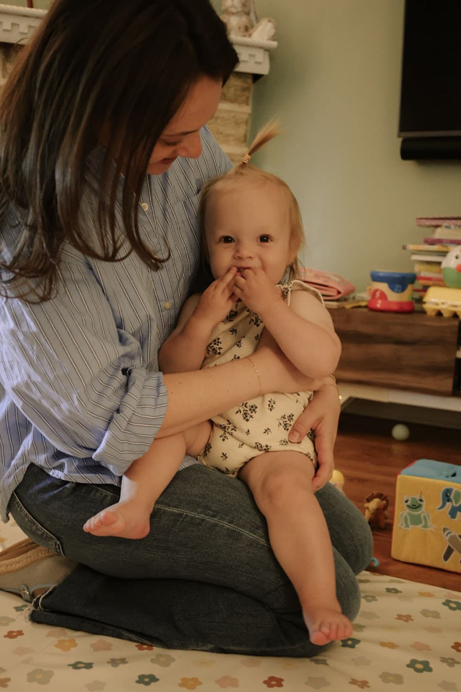 Mother holding her toddler at home
